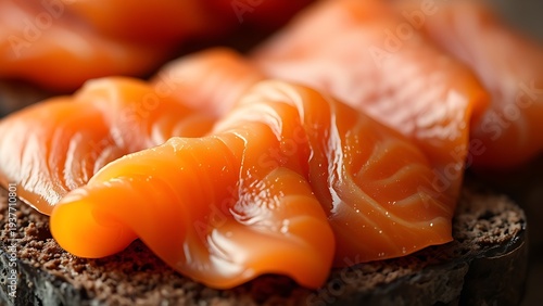 tonalite. Close-up of oily smoked salmon slices on dark rye bread. menu design, packaging mockups, designed for culinary blogs and recipe cards for restaurants, used by interior designers.