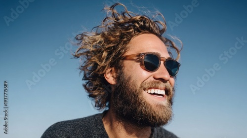 Smiling man with sunglasses enjoying a sunny day with blue sky background