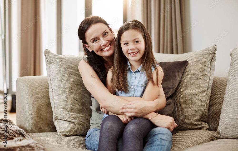Obraz premium Mom, girl and hug on sofa for portrait with smile, bonding and relax in living room for connection in home. People, mother and daughter on couch, happy or relationship at family house in Australia