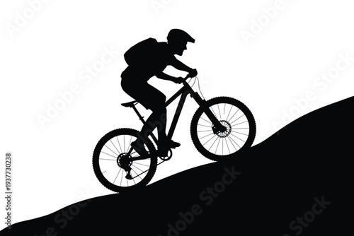 Silhouette of a person riding a mountain bike on a slope