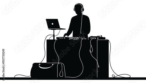 A DJ silhouette standing behind a sound mixer with a laptop
