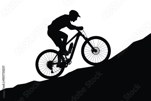 Silhouette of a person mountain biking on a hill bicycle
