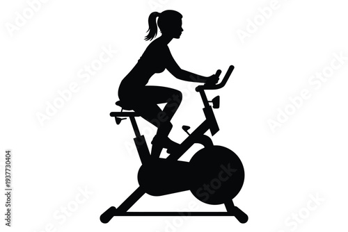 Silhouette of a woman exercising on a stationary bike 1