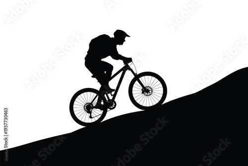 Silhouette of mountain biker riding on a slope bicycle