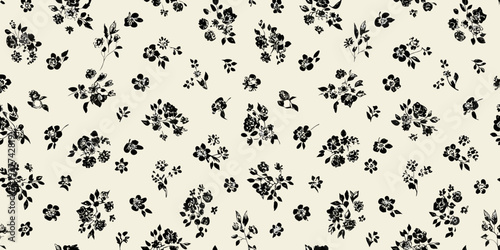 Delicate black floral pattern on a cream colored background texture