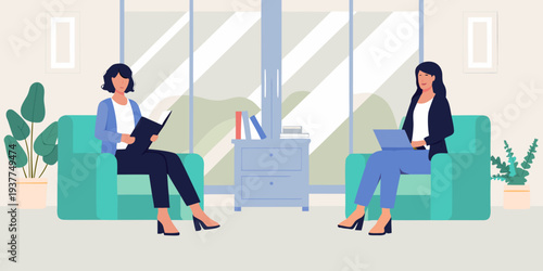 Two women in armchairs having a conversation in a modern office setting