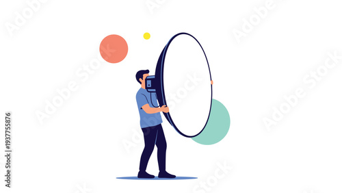 Professional photographer or technician carries a large round studio reflector or light modifier for a photo shoot.