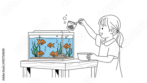 Little girl carefully uses small net to feed several bright orange goldfish swimming in a glass aquarium on wooden table.