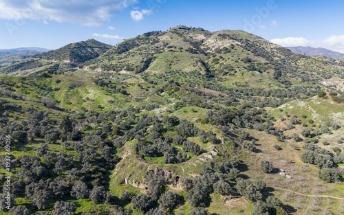 Aerial drone view of Mastaura Antik Kenti in Aydin, Turkey, showcasing ancient ruins, the well-preserved Roman amphitheater, and surrounding landscape from above.