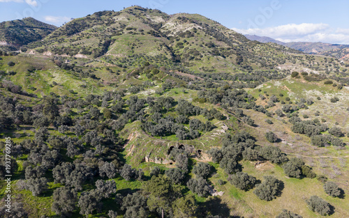 Aerial drone view of Mastaura Antik Kenti in Aydin, Turkey, showcasing ancient ruins, the well-preserved Roman amphitheater, and surrounding landscape from above.