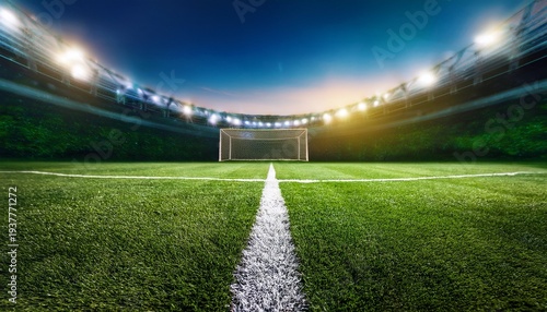 close up view of green grass and white line on a professional soccer football pitch with illuminated stadium field background for sport