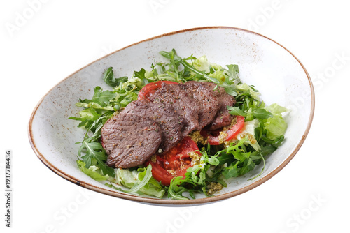 Beef salad with tomatoes and pesto sauce isolated on white background