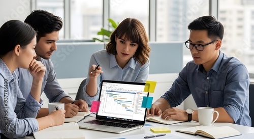 Diverse team collaborating on a business project with a laptop displaying charts.