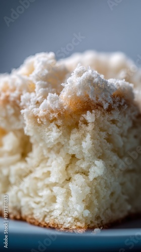 Close-up of fluffy moist coconut cake texture with golden crust