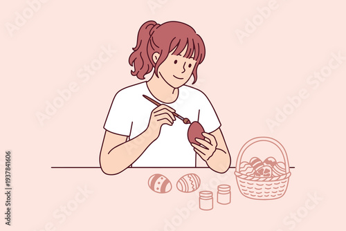 Creative young woman painting and decorating easter eggs at home with brush and colorful paints to prepare for traditional spring holiday celebration