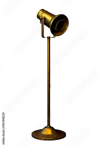An antique brass spotlight on a stand against a solid black background on transparent background