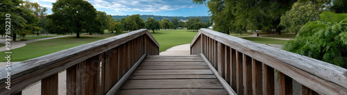 Panel kuchenny z motywem Wooden bridge park green grass trees pathway summer blue sky outdoor tranquil scenic view
