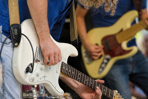 Two guitarists on a daytime stage