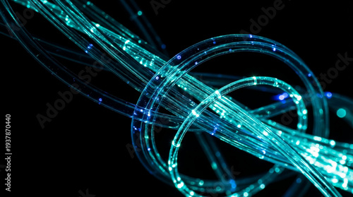 Glowing teal fiber optic cables twisted and intertwined on dark black background