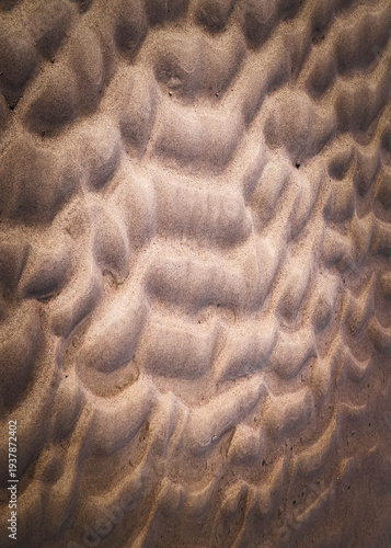 Traces of waves on sand as a natural background.