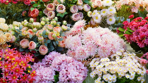 Tableau sur toile Colorful artificial flowers on display in a flower shop