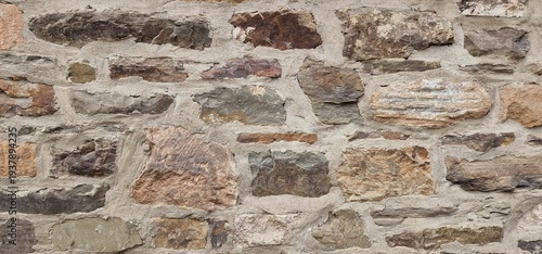 A medieval wall made of uneven stones arranged in a structured pattern