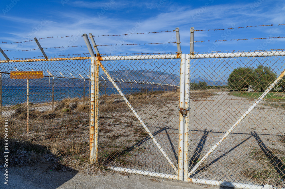 Fototapeta premium Rusted fence at the Lechaion basilica ruins, Korintos, Greece