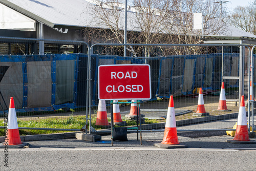 Photography Road closed sign with traffic cones and temporary construction fencing