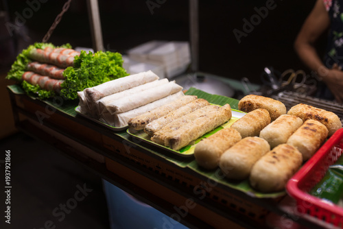 Canvas Print Assorted Vietnamese Spring Rolls and Fried Snacks at Night Market Stall
