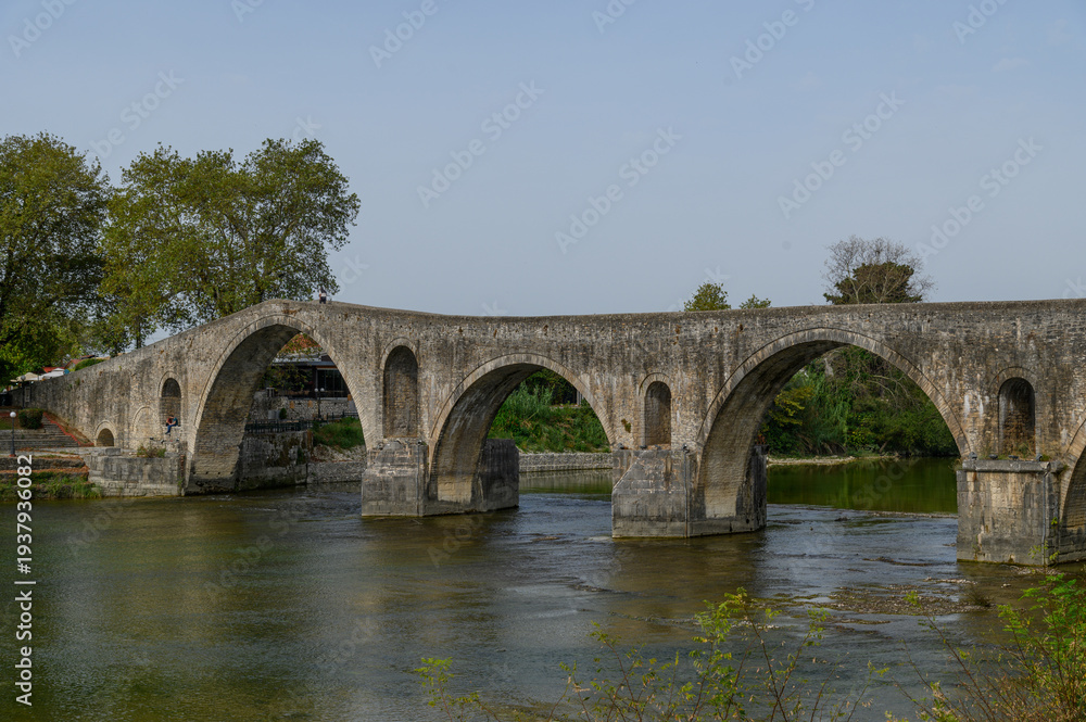 Fototapeta premium Old Stone Bridge over the River in Arta, Greece