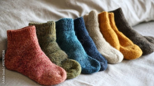 Handmade colorful wool socks lined up on linen