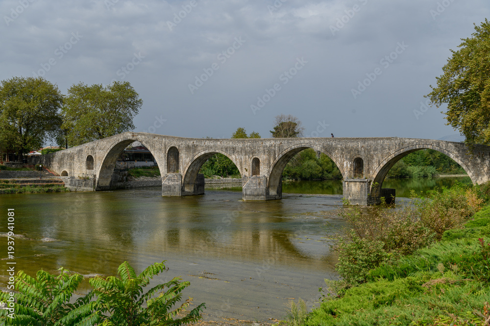 Fototapeta premium Old Stone Bridge over the River in Arta, Greece