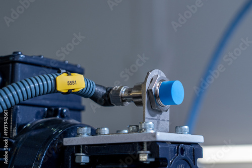 Photos Industrial Proximity Sensor with Blue Cap Mounted on Automated Machinery
