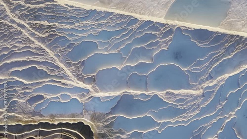 Cinematic aerial drone video of Pamukkale travertines and thermal pools in Denizli, Turkey, highlighting the white calcium terraces, natural formations, and panoramic scenic landscape from above.