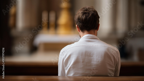 Man praying on bench in Christian church, male worship in sanctuary, seated prayer moment, ecclesiastical devotion display, congregational meditation scene, faceless praying figure