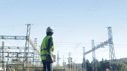 Cuadro en lienzo Electrical engineer monitoring high voltage equipment and power lines at a trans