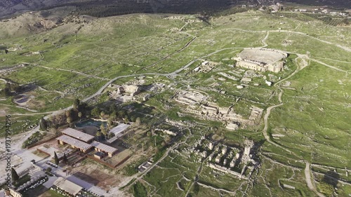 Cinematic aerial drone video of Hierapolis Antik Kenti and Pamukkale travertines in Denizli, Turkey, showcasing the Roman theater, columns, ruins, and dramatic landscape from above.