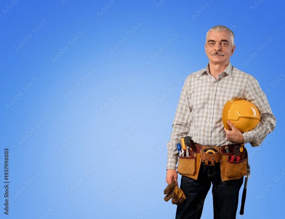 Naklejka premium Worker man wearing hardhat holding tools