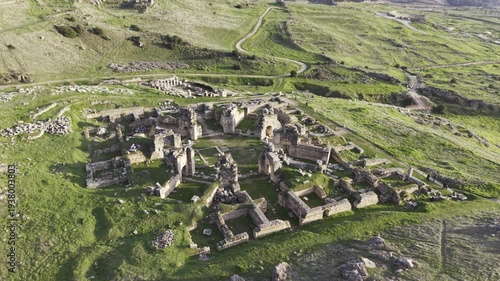 Cinematic aerial drone video of Hierapolis Antik Kenti and Pamukkale travertines in Denizli, Turkey, showcasing the Roman theater, columns, ruins, and dramatic landscape from above.