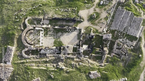 Cinematic aerial drone video of Hierapolis Antik Kenti and Pamukkale travertines in Denizli, Turkey, showcasing the Roman theater, columns, ruins, and dramatic landscape from above.