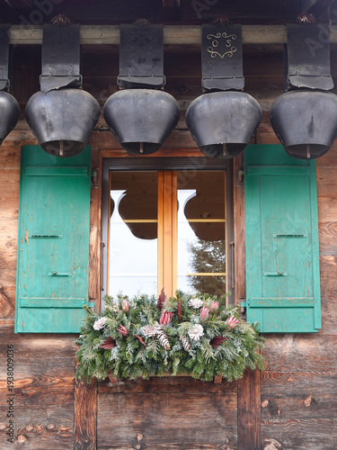 Cow bells hanging over an open chalet window, Gstaad Switzerland