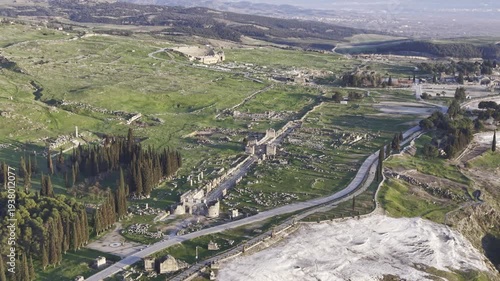 Cinematic aerial drone video of Hierapolis Antik Kenti and Pamukkale travertines in Denizli, Turkey, showcasing the Roman theater, columns, ruins, and dramatic landscape from above.