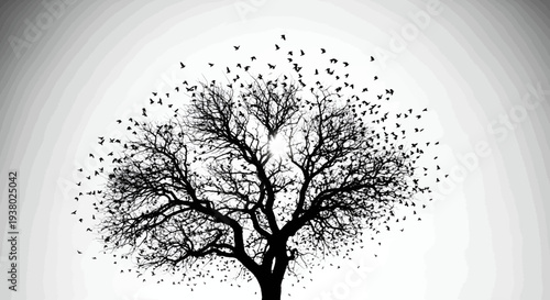 Silhouette of a bare tree with a flock of birds flying around and perched on branches against a bright sky