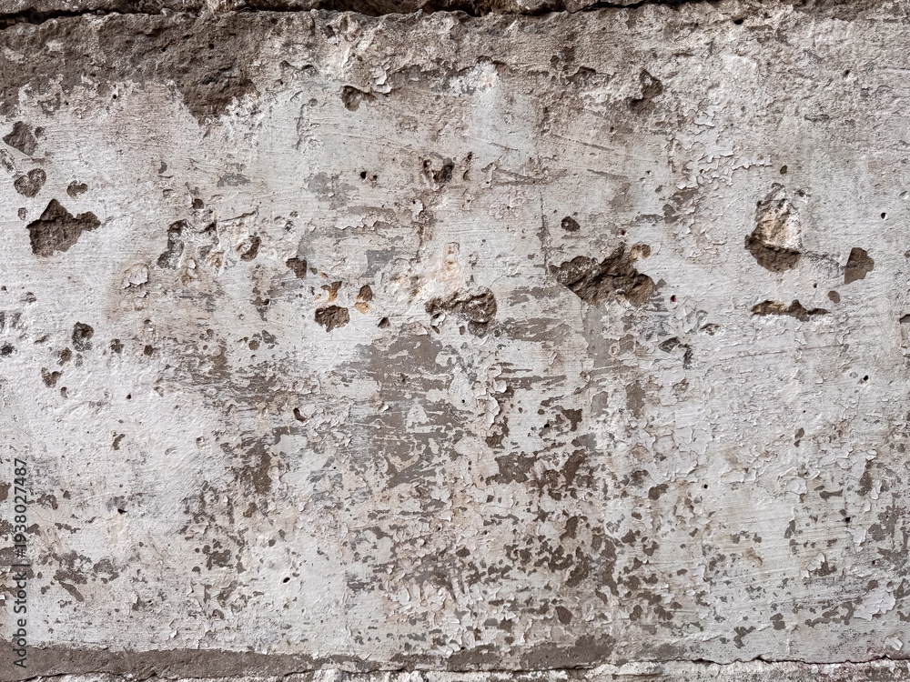 Fototapeta premium Old weathered white painted wall with peeling paint and exposed concrete surface texture