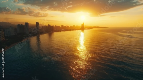 Stunning Golden Sunset Over Coastal City Skyline and Reflective Ocean Waters.