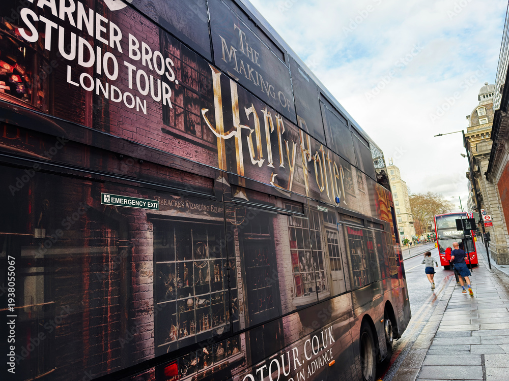 Fototapeta premium London street scene with a red double decker bus and Harry Potter studio tour