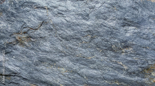 Stone textured dark background with light inclusions, rock formation