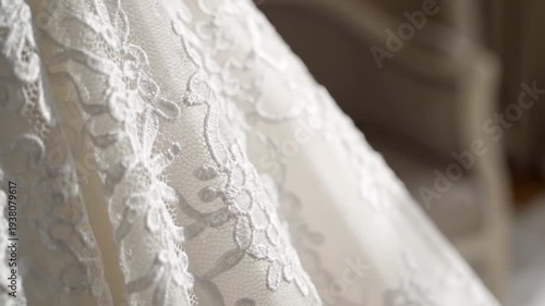Detail of white wedding dress with lace embroidery. Elegant bridal gown fabric texture close up. Luxury fashion garment for marriage ceremony and celebration.