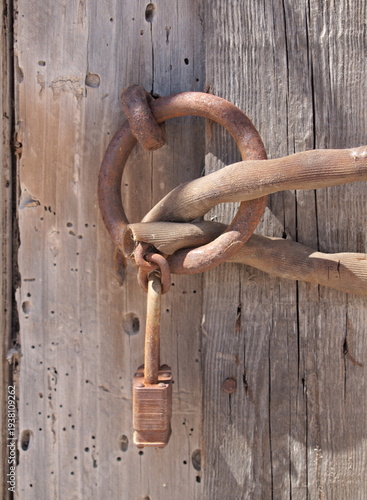 Wallpaper Mural Old rusty padlock securing weathered wooden barn door Torontodigital.ca