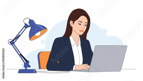 Diligent young businesswoman in a navy suit works late on her laptop at a home office desk illuminated by a bright blue lamp.